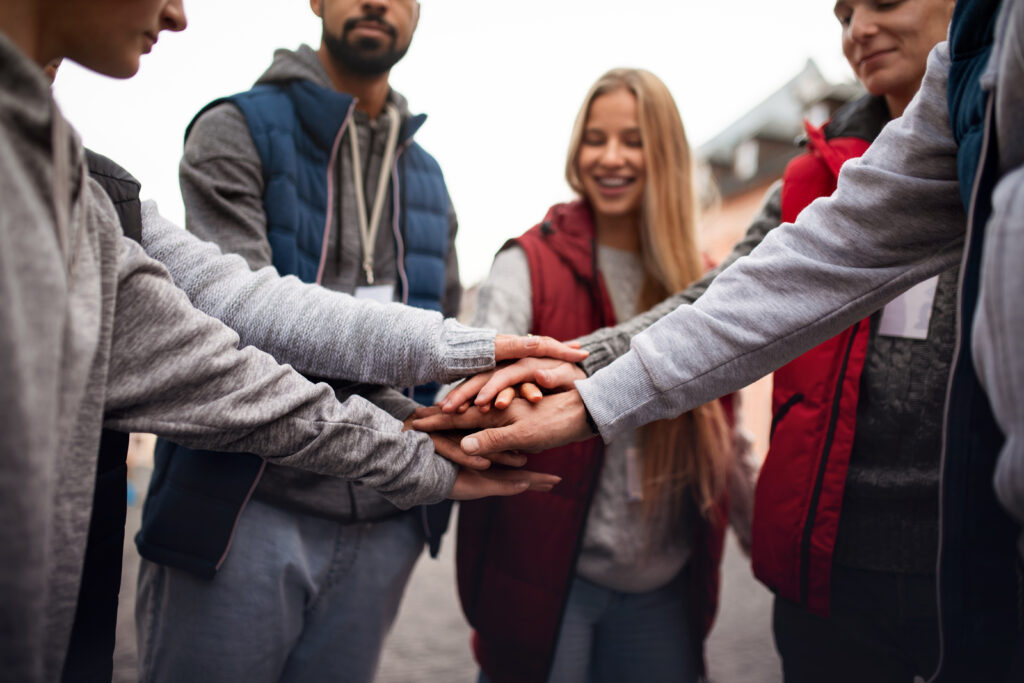 close up of a group doing a team hand shake
